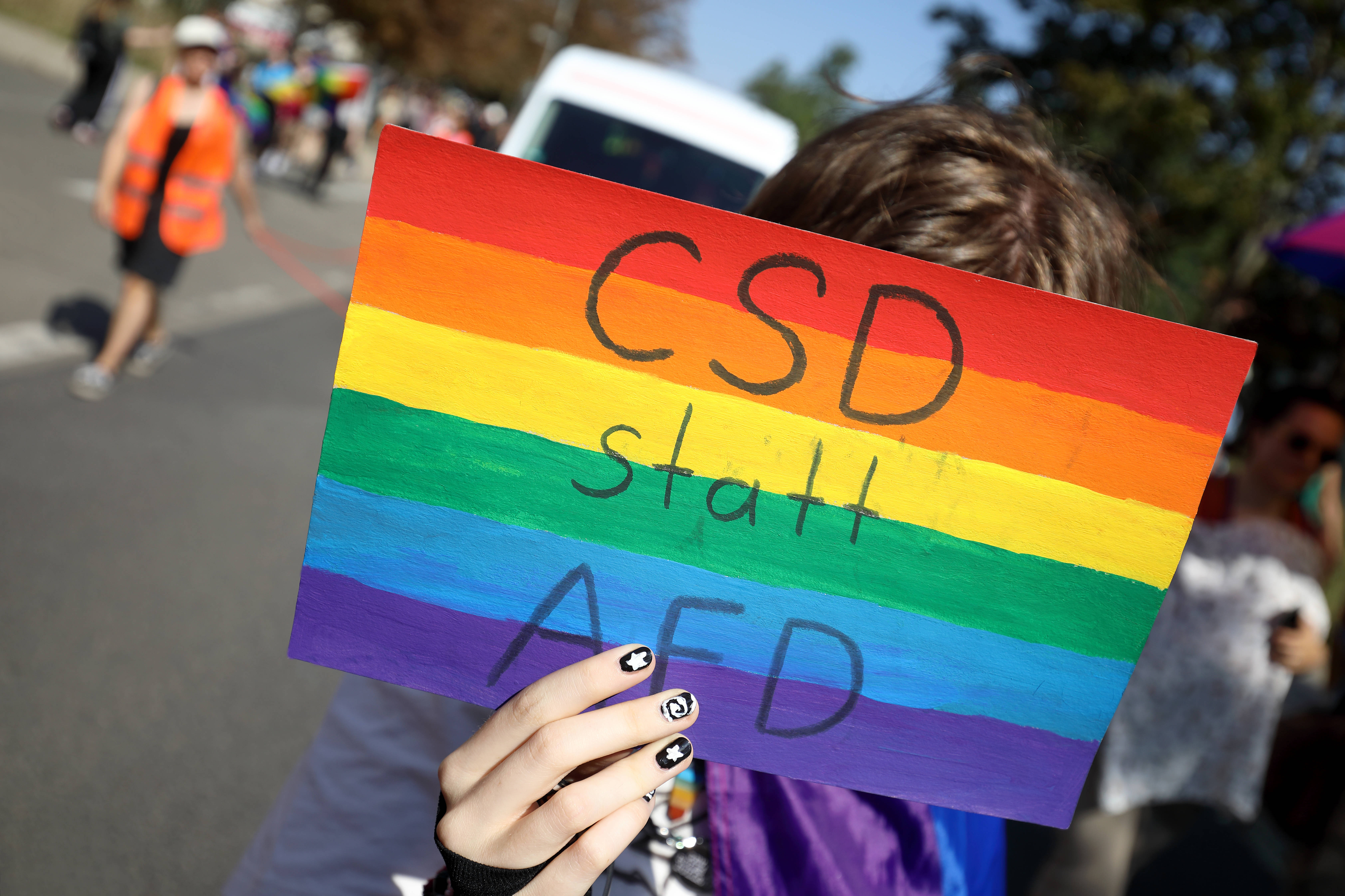 Schild mit Regenbogenfahne und der Aufschrift "CSD statt AfD"