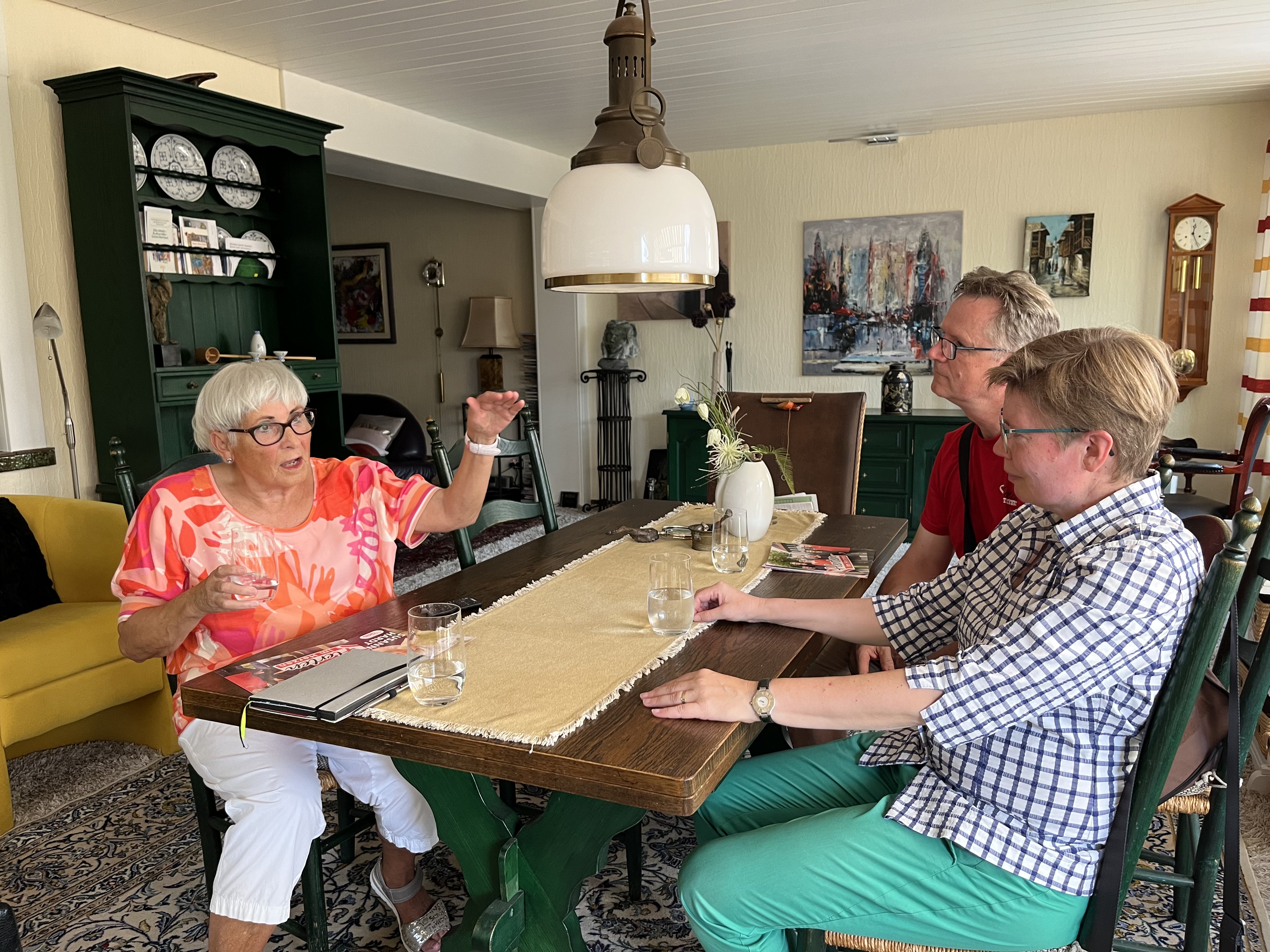 Genossin Elisabeth Linkmann lädt Babette Nieder und Bodo Ladwig in ihr Wohnzimmer.